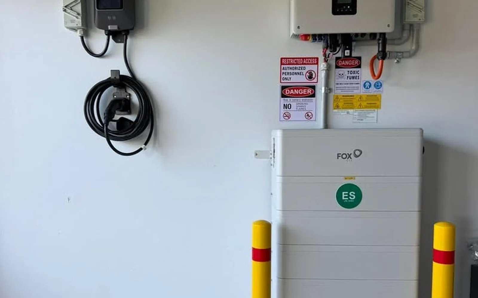 Home battery installed beside an EV charger in a garage