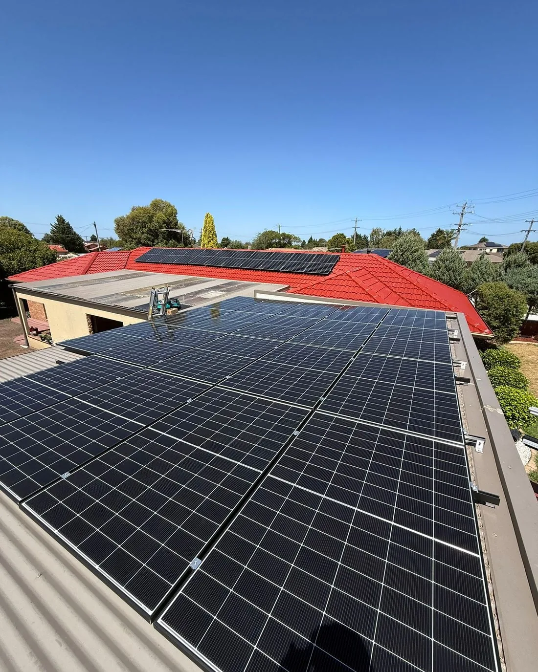 Solar panels being installed on a tiled roof